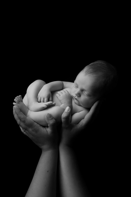 Baby in hands newborn posing photoshoot 
